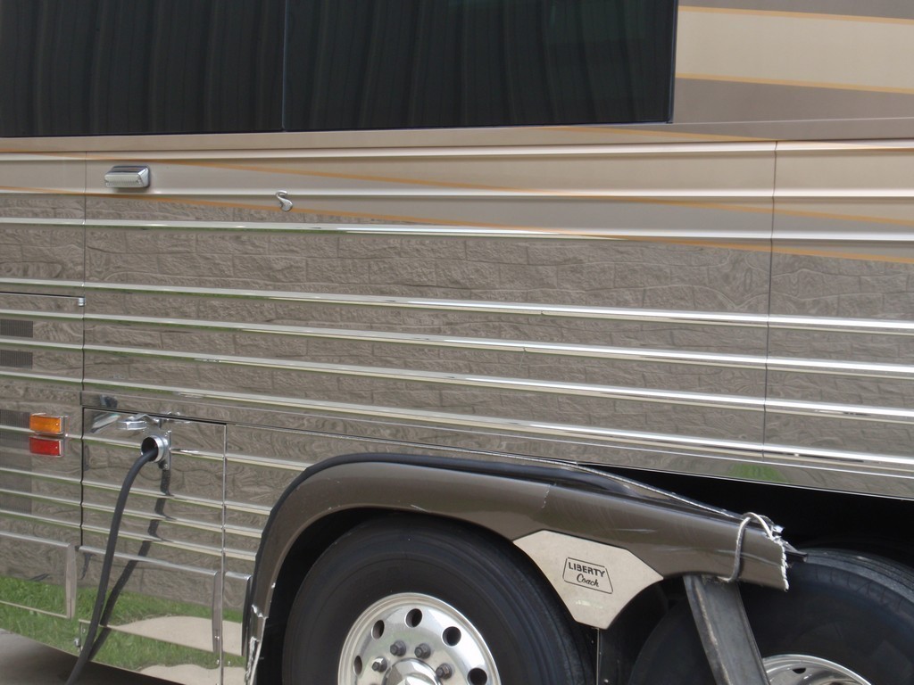 Prevost XL II Collision - Passenger side wheel well fender damage before repairs by Excalibur Coach