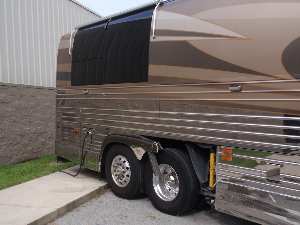 Prevost XL II Collision - Passenger side wheel well damage before repairs by Excalibur Coach