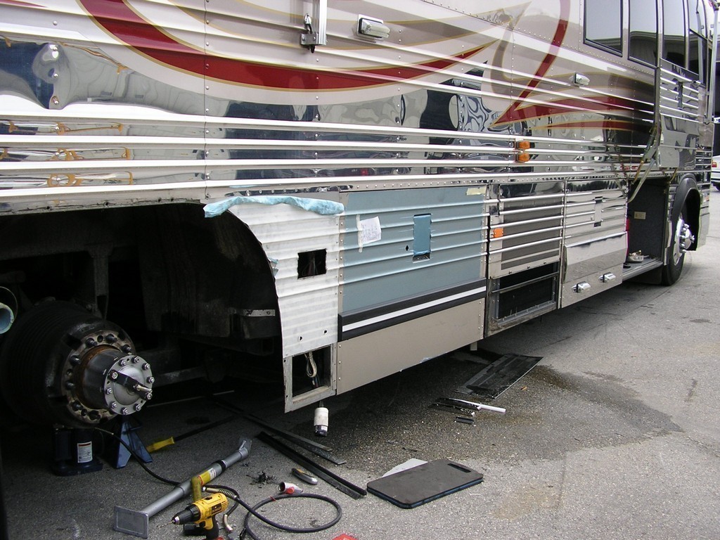 Prevost Xl Liberty Collision -passenger side wheel well being repaired by Excalibur Coach with new bay door on