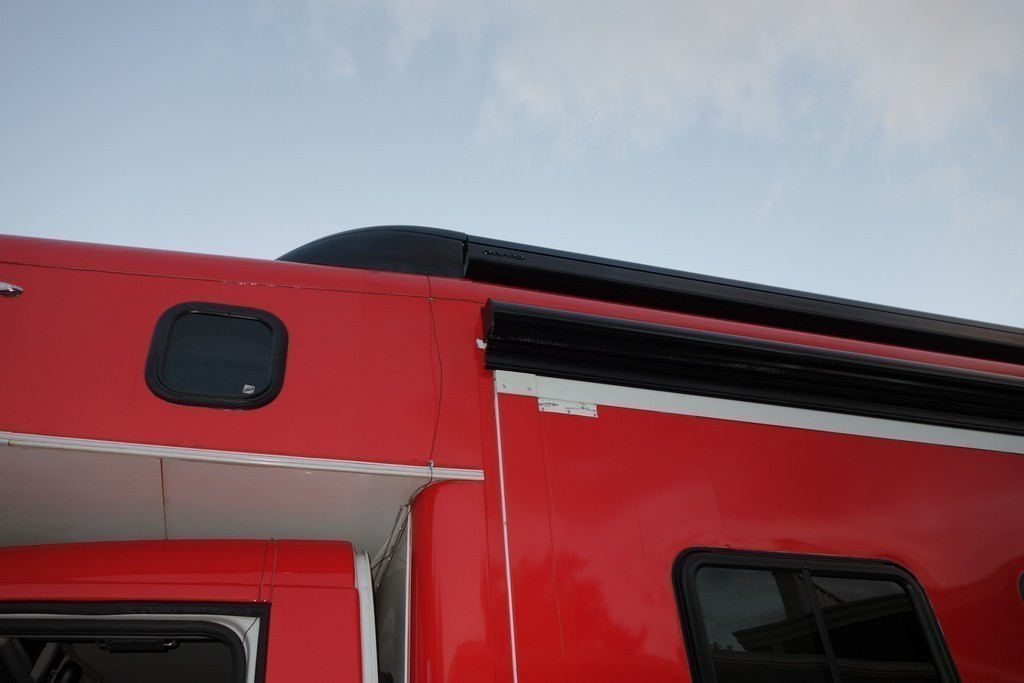 Showhauler Motorhome with new awning and awning bullets by Excalibur Coach