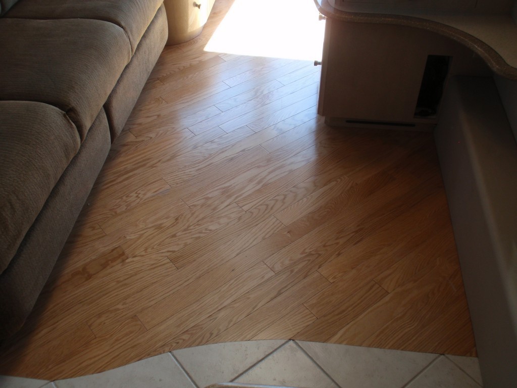 Prevost H3-45 XL II Motorhomes Class A - New wood floor in salon showing transition to galley by Excalibur Coach